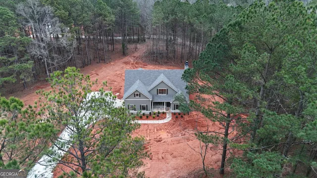 an aerial view of a house with a yard