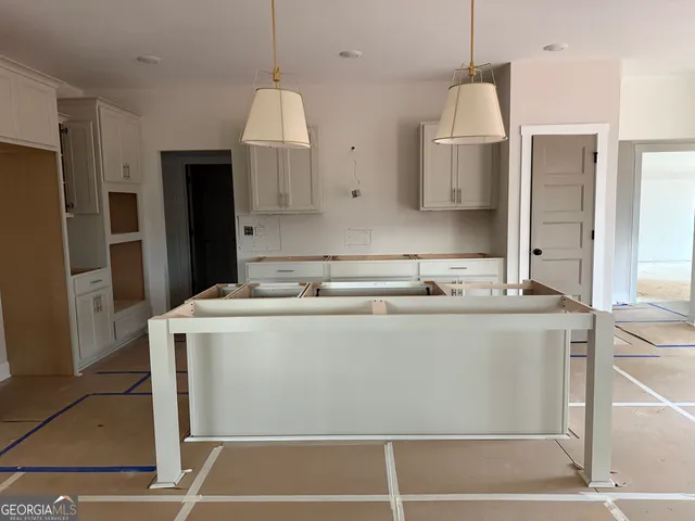 a view of a kitchen with stainless steel appliances granite countertop a stove a refrigerator and a sink