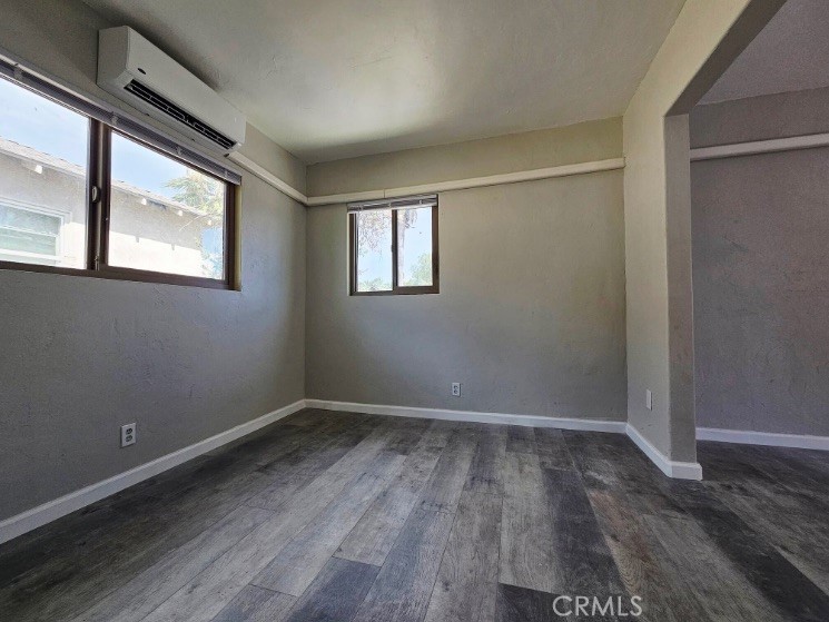 3643 Brockton Avenue, Unit F Riverside, CA 92501 - Photo 4 of 4 a view of an empty room with wooden floor and a window