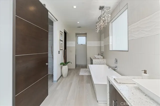 a bathroom with a granite countertop sink a toilet and shower