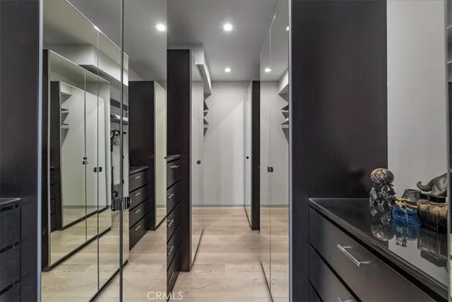 a bathroom with a double vanity sink a toilet a mirror and shower