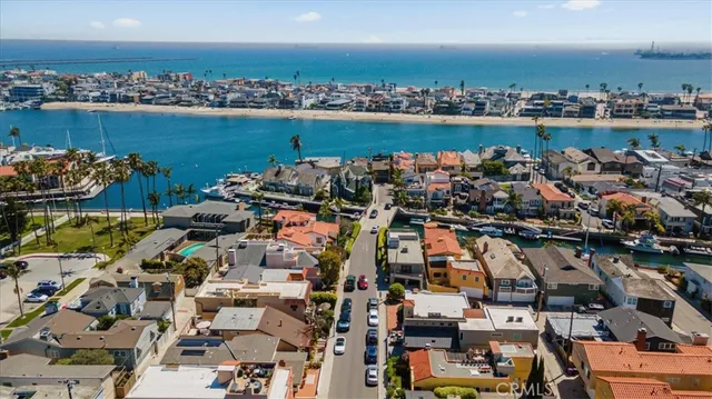 an aerial view of ocean and residential building with outdoor space