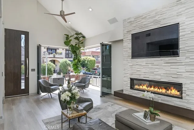 a living room with furniture a fireplace and a flat screen tv