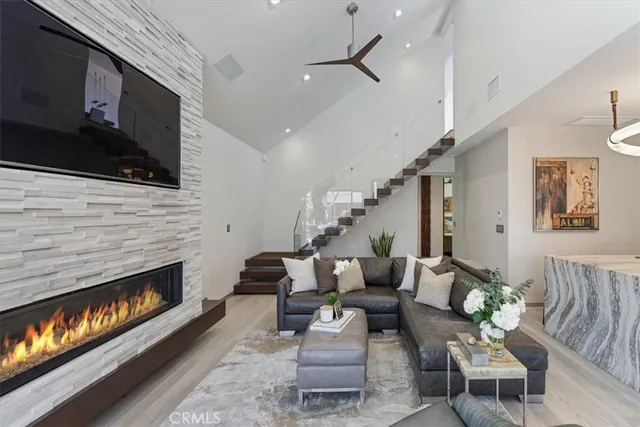 a living room with furniture fireplace and flat screen tv