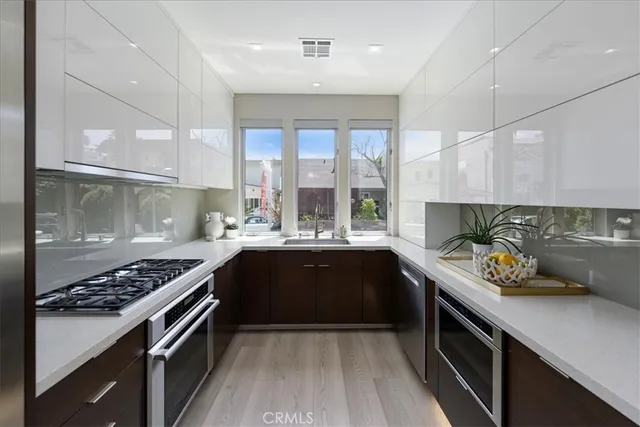 a kitchen with a sink stove and cabinets