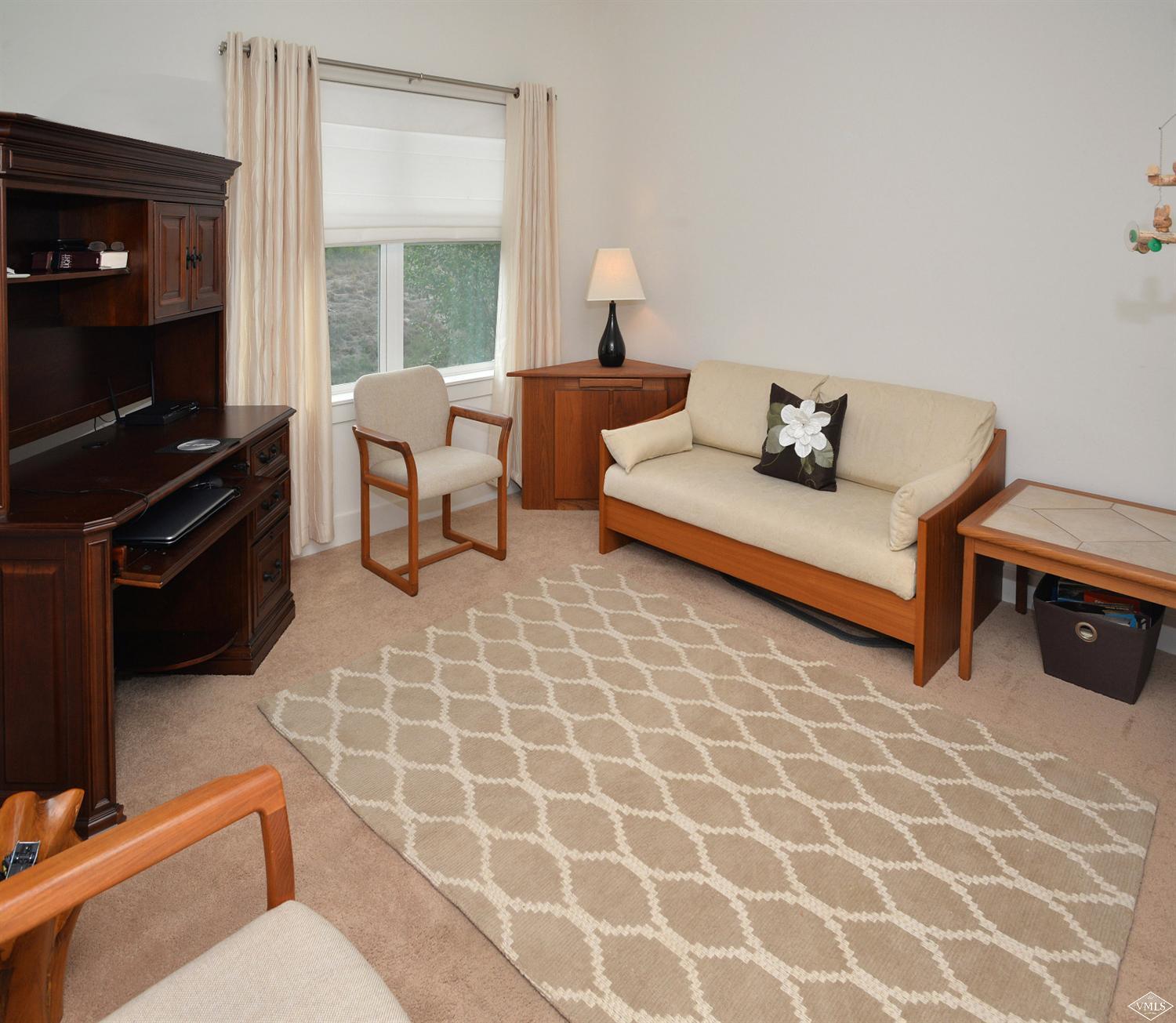 80 Freestone Road, Unit B201 Eagle, CO 81631 - Photo 11 of 15 a living room with furniture a flat screen tv and a window
