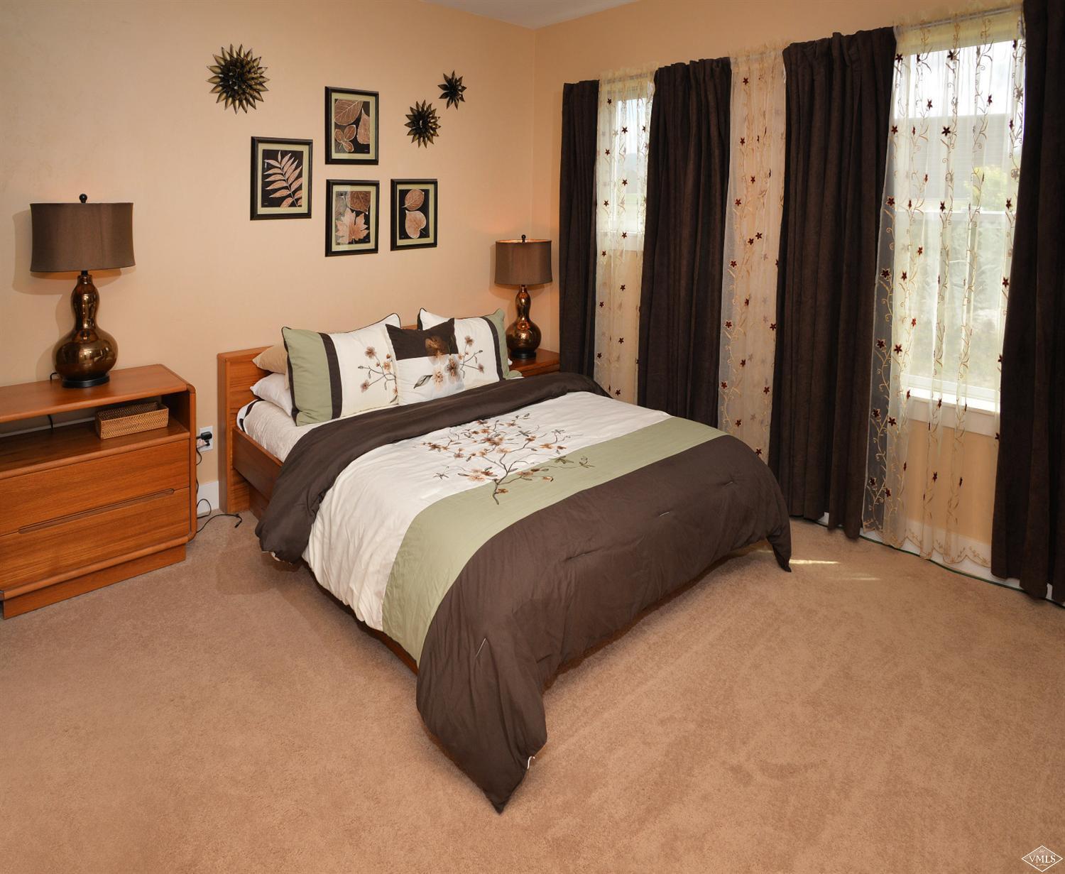 80 Freestone Road, Unit B201 Eagle, CO 81631 - Photo 12 of 15 a large bed sitting in a bedroom next to a window
