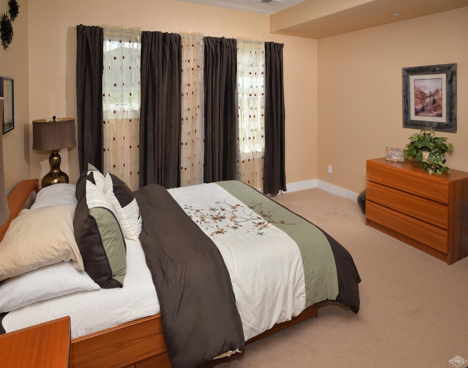 80 Freestone Road, Unit B201 Eagle, CO 81631 - Photo 13 of 15 a bedroom with a bed and a dresser