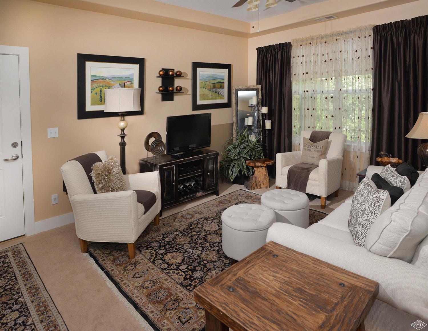 80 Freestone Road, Unit B201 Eagle, CO 81631 - Photo 3 of 15 a living room with furniture a flat screen tv and a large window