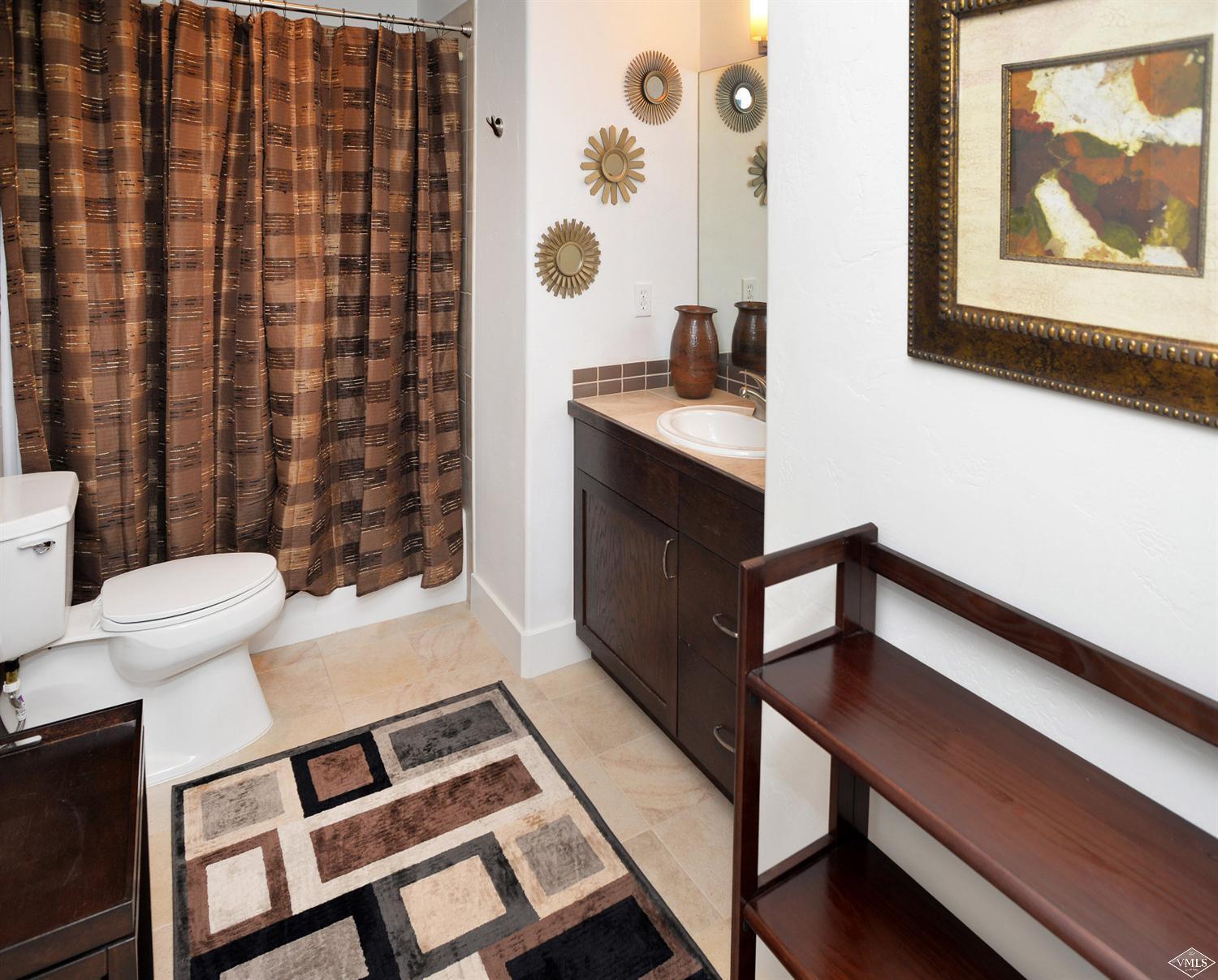 80 Freestone Road, Unit B201 Eagle, CO 81631 - Photo 10 of 15 a bathroom with a sink a toilet and shower