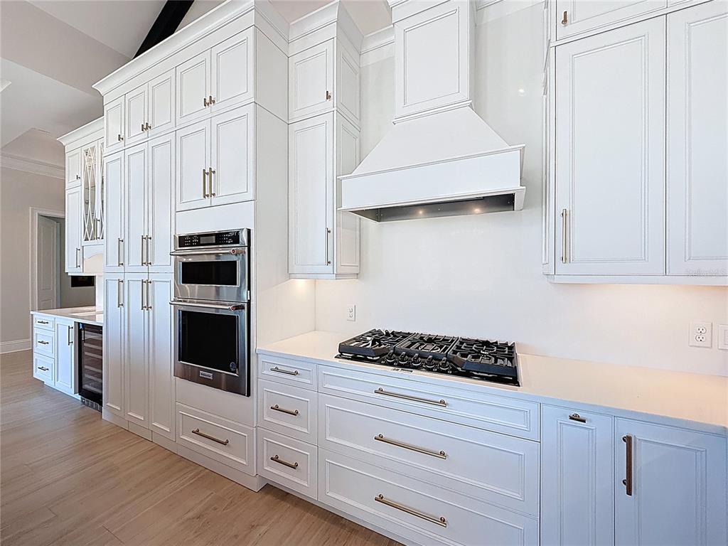 7394 Gathering Court Reunion, FL 34747 - Photo 12 of 44 a kitchen with stainless steel appliances white cabinets and a stove