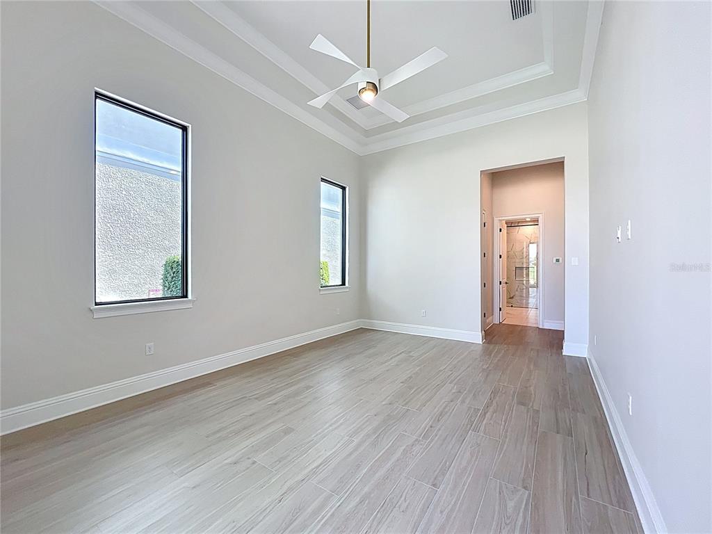 7394 Gathering Court Reunion, FL 34747 - Photo 15 of 44 a view of an empty room with wooden floor and a window