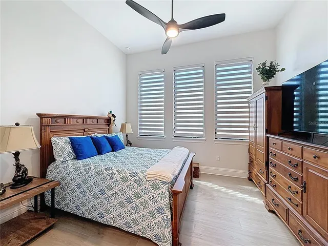 a bedroom with a large bed and a window