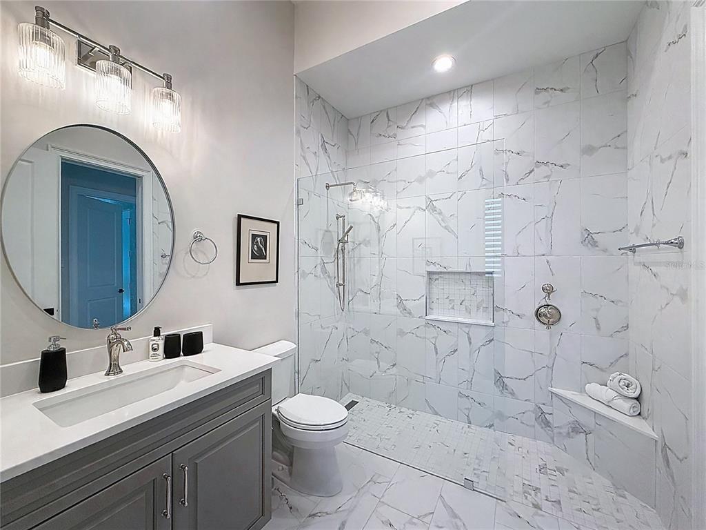 7394 Gathering Court Reunion, FL 34747 - Photo 20 of 44 a bathroom with a sink a toilet and shower