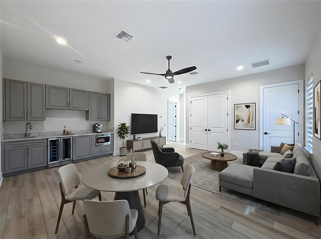 7394 Gathering Court Reunion, FL 34747 - Photo 24 of 44 a living room with stainless steel appliances furniture a dining table and chairs