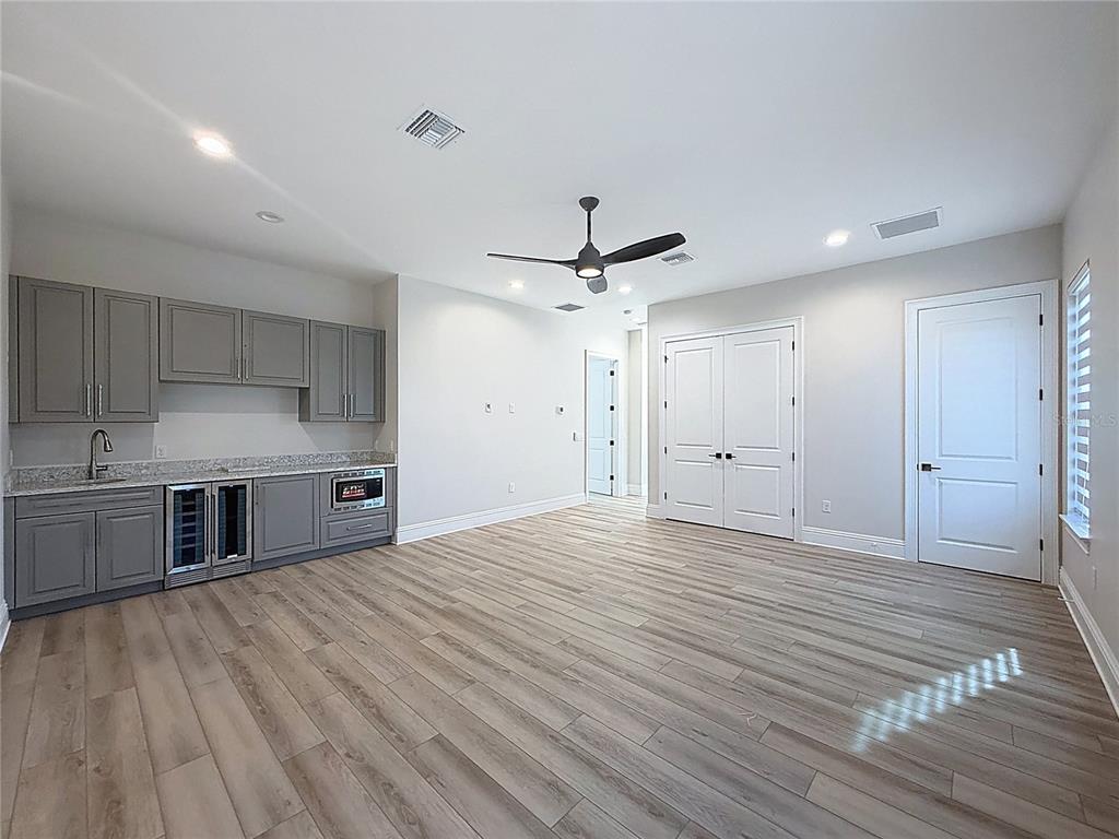 7394 Gathering Court Reunion, FL 34747 - Photo 25 of 44 a view of a kitchen with stainless steel appliances a sink and wooden floor