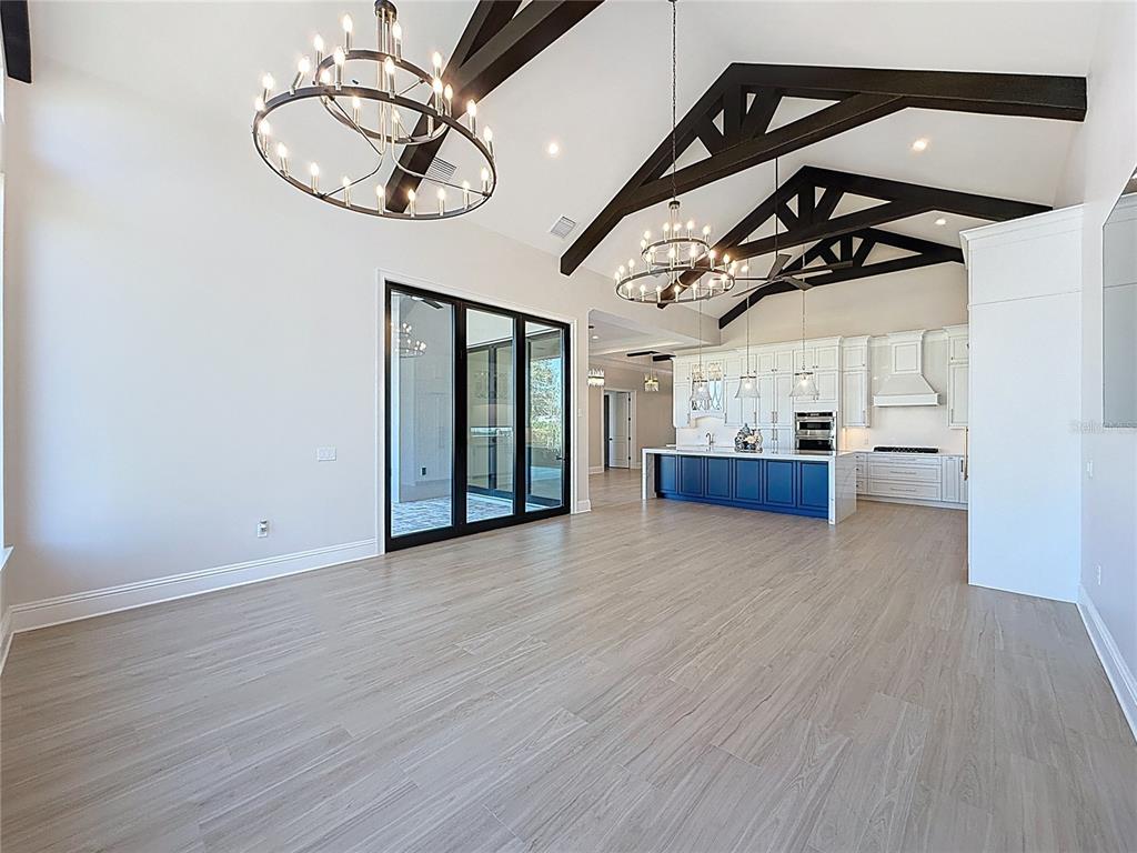 7394 Gathering Court Reunion, FL 34747 - Photo 5 of 44 a view of a livingroom with wooden floor and a ceiling fan