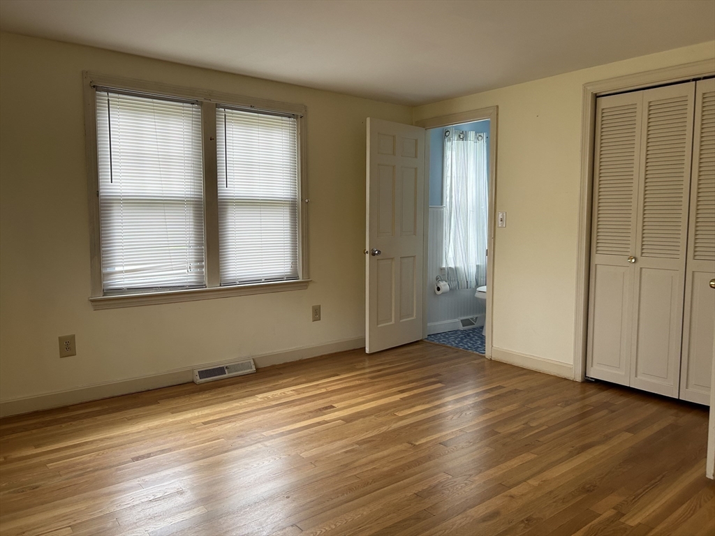 32 Westminster Road Centerville, MA 02632 - Photo 17 of 23 an empty room with wooden floor and windows