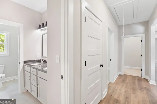 a kitchen with white cabinets and sink