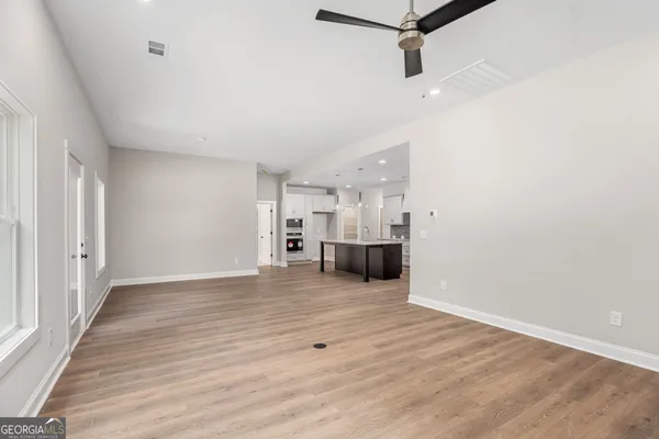 a view of a kitchen with a sink and cabinets