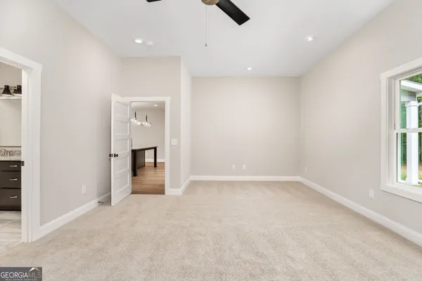 an empty room with windows and closet