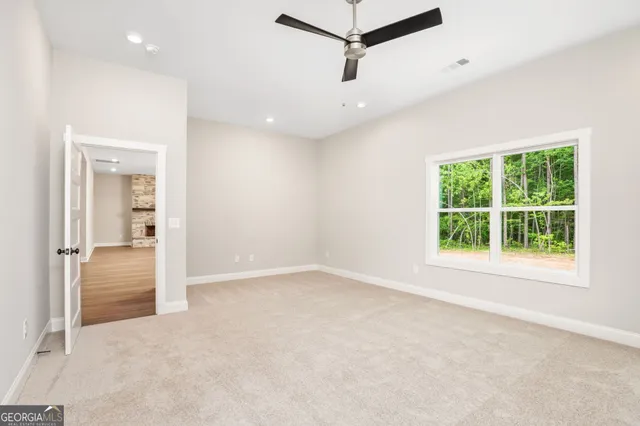 an empty room with windows and closet