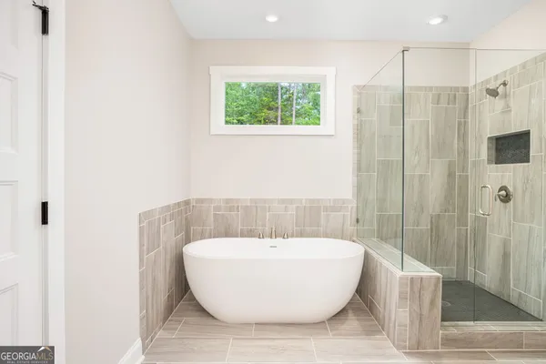a bathroom with a bathtub and shower