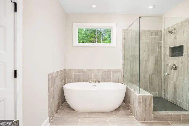 a bathroom with a bathtub and shower