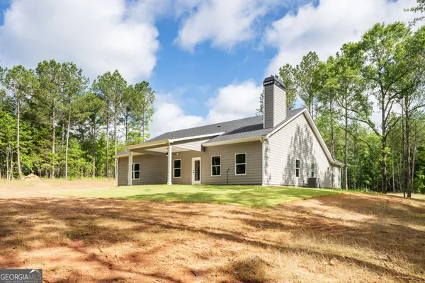 a view of a white house with a yard