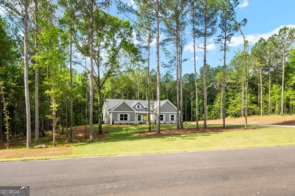 a view of a swimming pool with palm trees and a yard