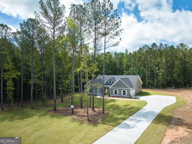 a view of a house with swimming pool and a yard