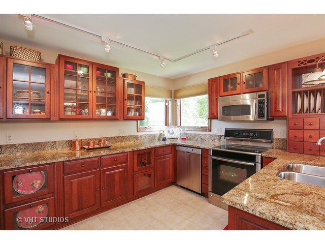9N100 Percy Road Maple Park, IL 60151 - Photo 2 of 10 a kitchen with stainless steel appliances granite countertop a stove sink and microwave