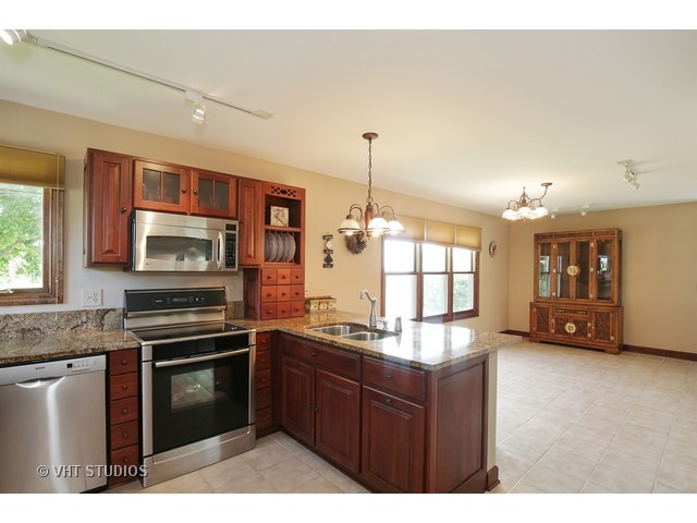 9N100 Percy Road Maple Park, IL 60151 - Photo 3 of 10 a kitchen with a stove and a sink