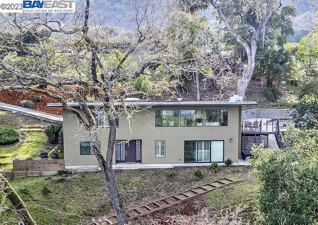 a house that has a tree in front of the house