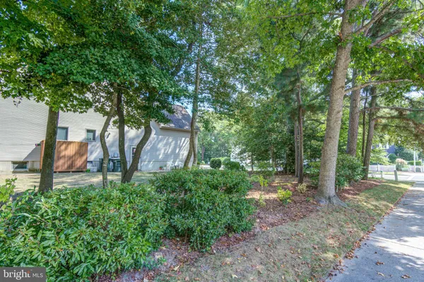 a backyard of a house with lots of green space and fountain
