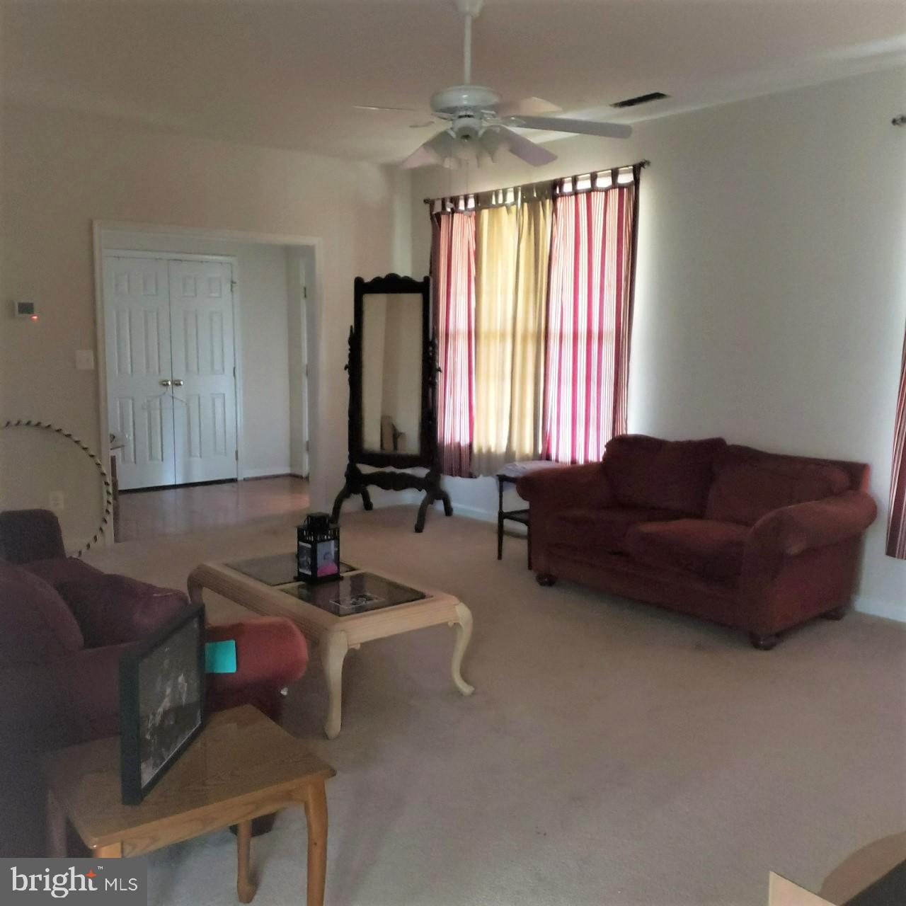 8405 Tee Road Lusby, MD 20657 - Photo 5 of 19 a living room with furniture and a large window