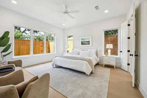 a spacious bedroom with a large bed and a large window