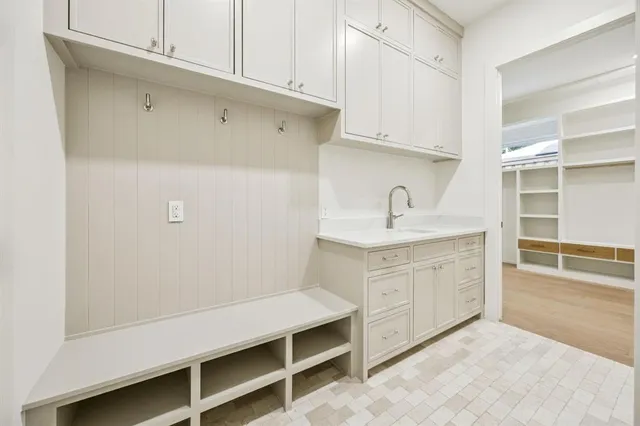 a room with a sink cabinets and utility
