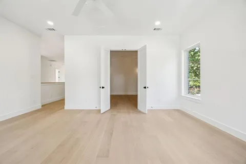 an empty room with windows and closet