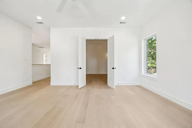 an empty room with windows and closet