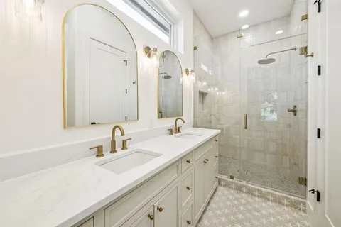 a bathroom with a shower sink and mirror