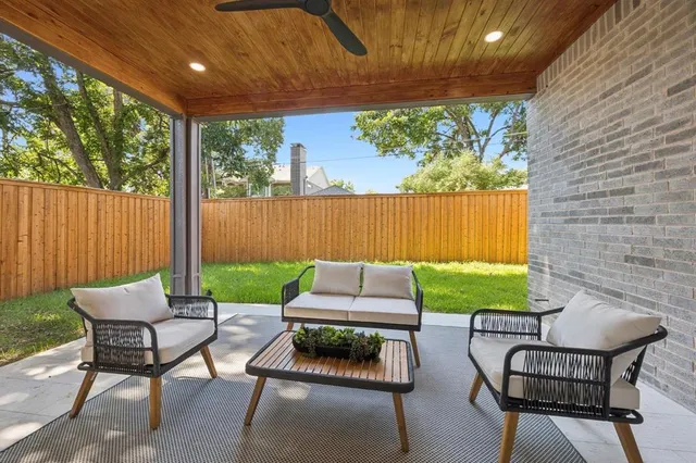 a backyard of a house with outdoor seating
