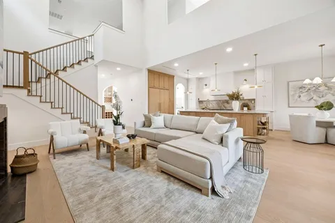 a living room with furniture and a view of kitchen