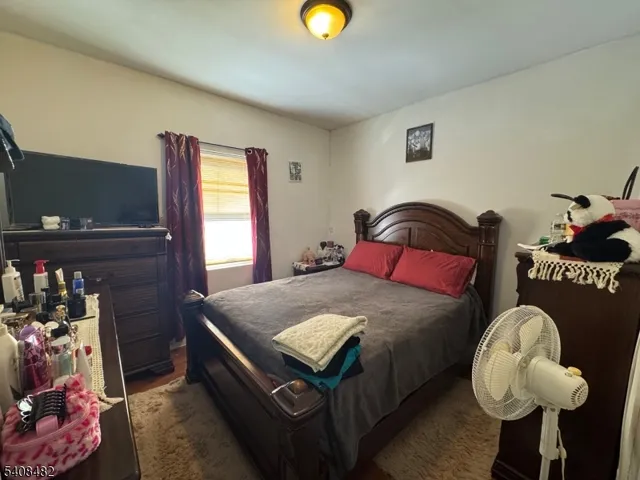 a bedroom with bed and a window