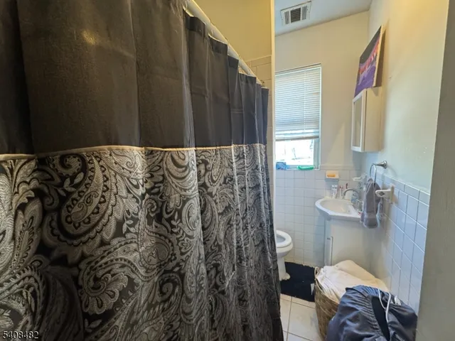 a bathroom with a shower curtain and a toilet