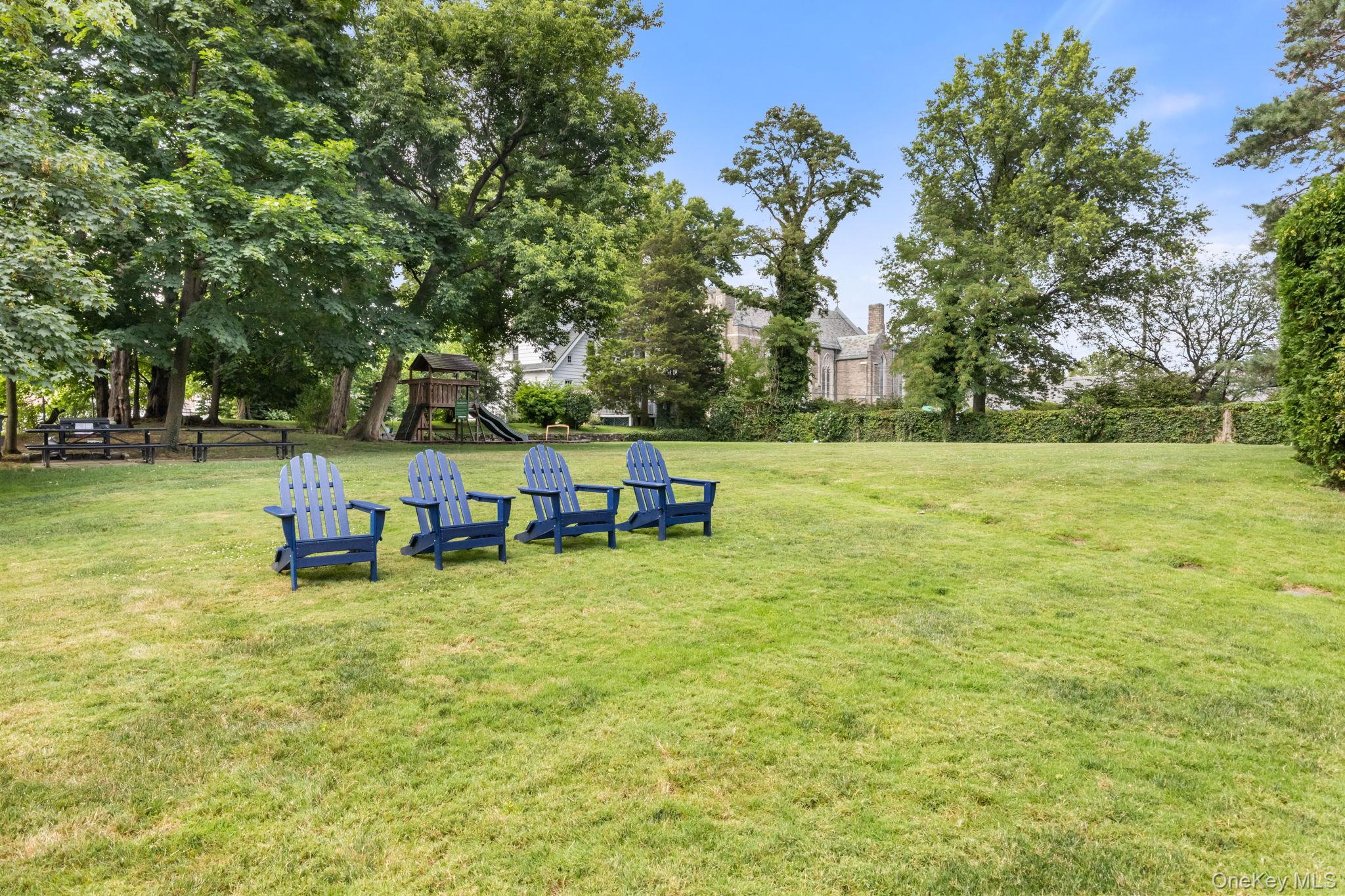 1 Midland Gardens, Unit 4A Bronxville, NY 10708 - Photo 11 of 12 a view of a lake with outdoor seating and trees
