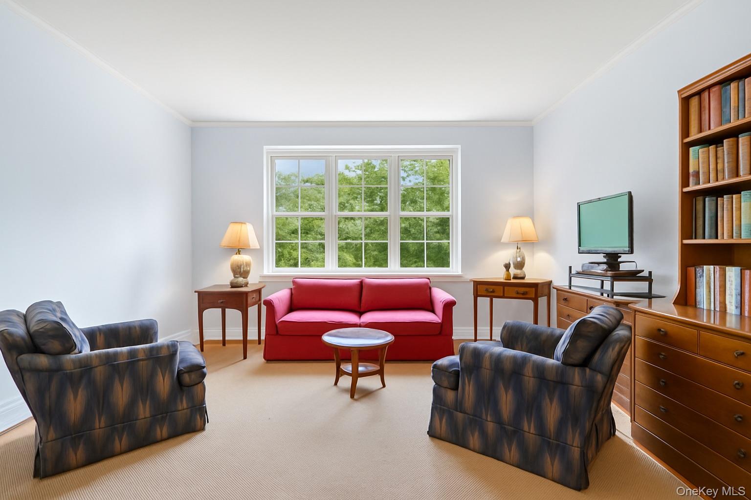 1 Midland Gardens, Unit 4A Bronxville, NY 10708 - Photo 6 of 12 a living room with furniture a bookshelf and a window