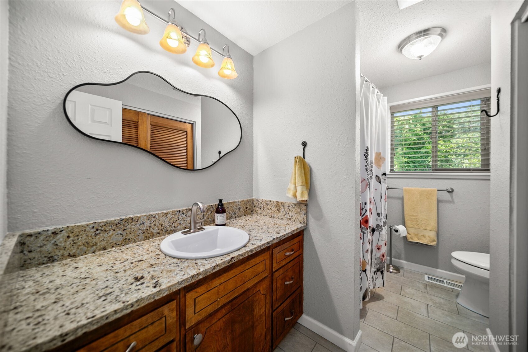 1901 Sleepy Hollow Road Wenatchee, WA 98801 - Photo 17 of 40 a bathroom with a granite countertop sink and a mirror