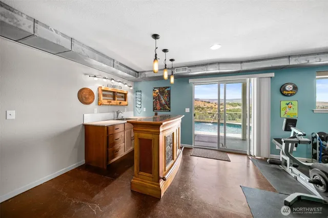 a kitchen with stainless steel appliances granite countertop a stove and a wooden floors