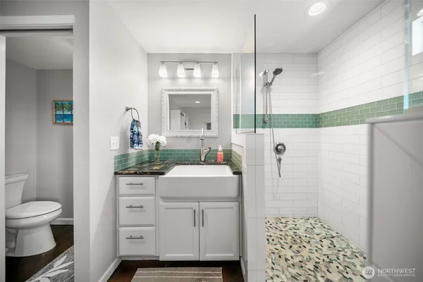 a bathroom with a sink toilet and shower